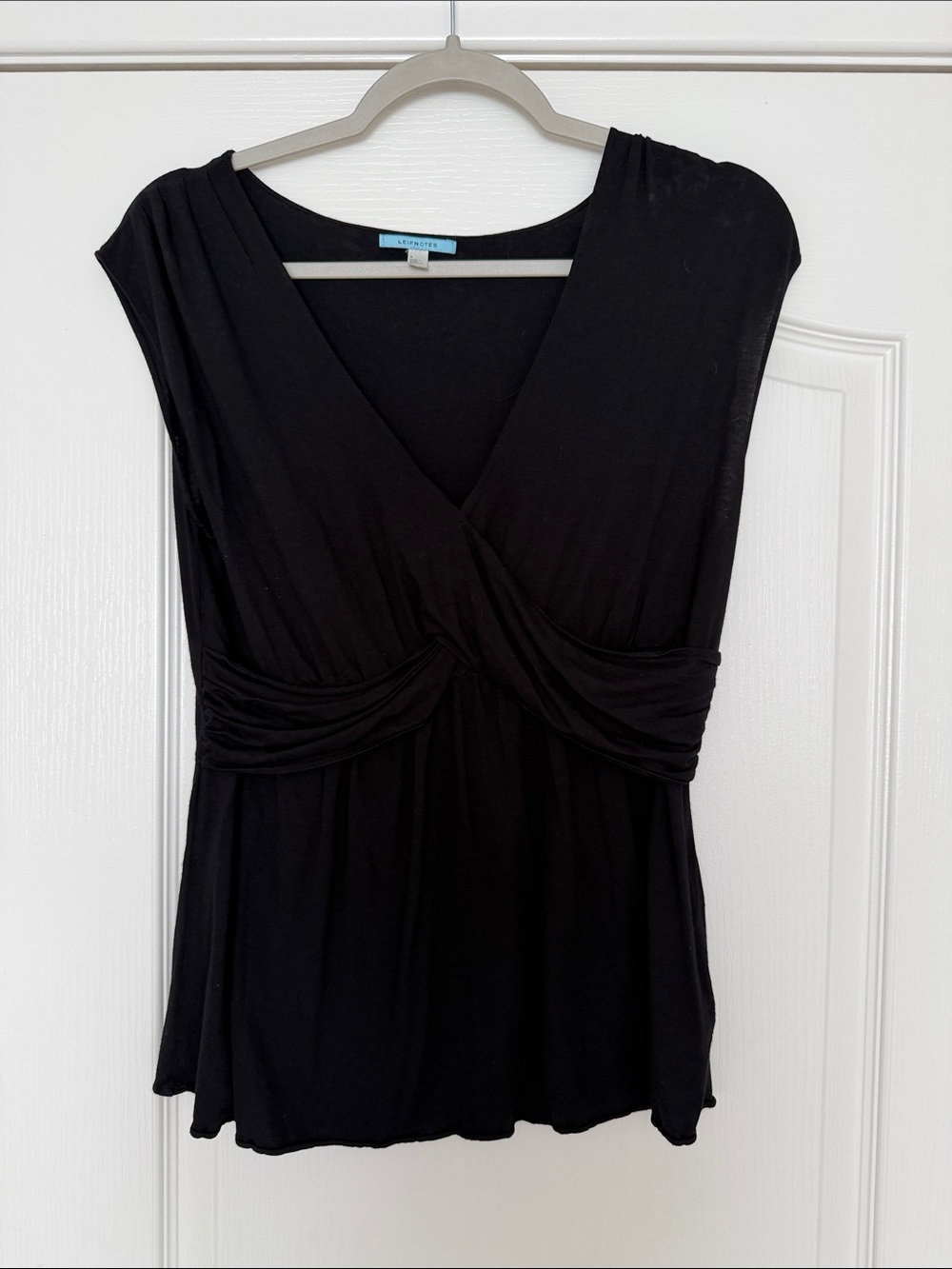 Black wrap front top by Leifnotes for Anthropologie.